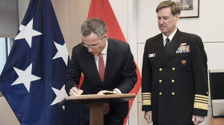 NATO Secretary General Jens Stoltenberg sings the Book of Honour of the Allied Joint Force Command, Naples in the presence of JFC Commander Admiral Mark Ferguson