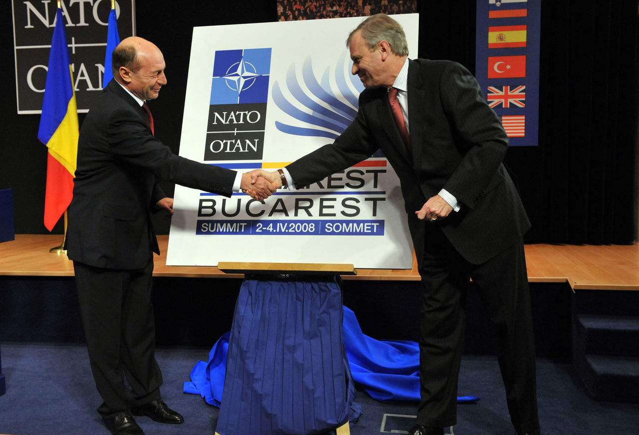 NATO Secretary General, Jaap de Hoop Scheffer and the President of Romania, Traian Basescu unveil the official logo for the upcoming NATO summit in Bucharest