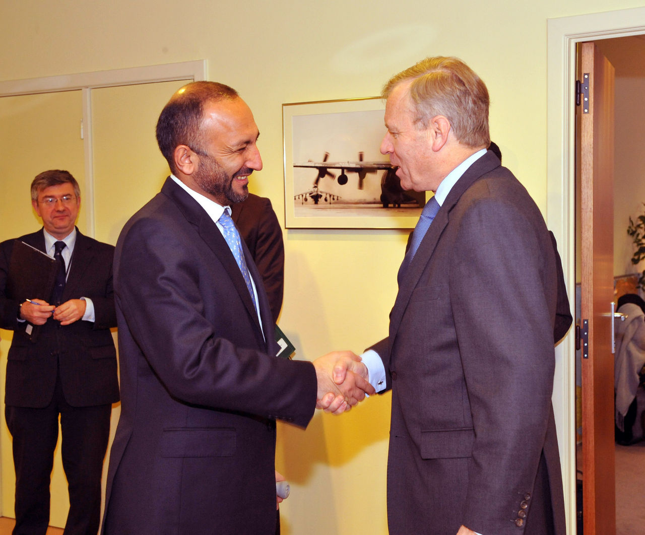 Left to right: Mohamad Hanif Atmar (Minister of the Interior, Afghanistan) shaking hands with NATO Secretary General, Jaap de Hoop Scheffer