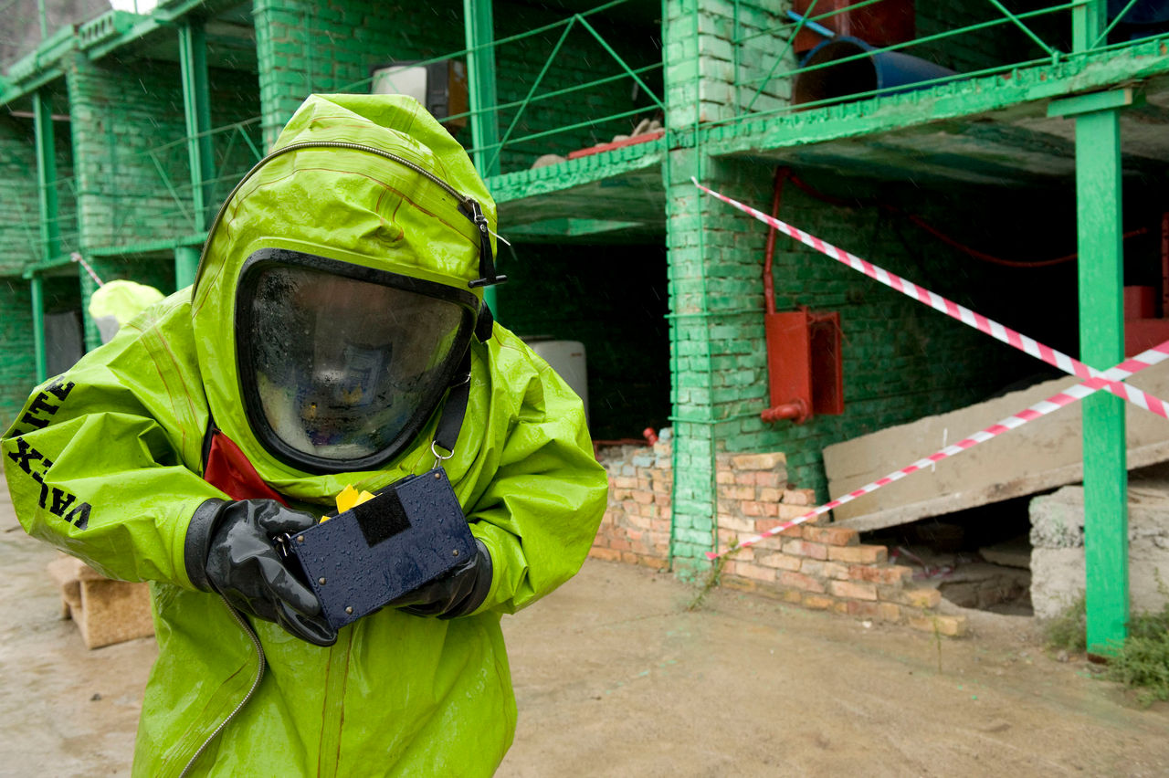 Chemical sampling in protective suit.