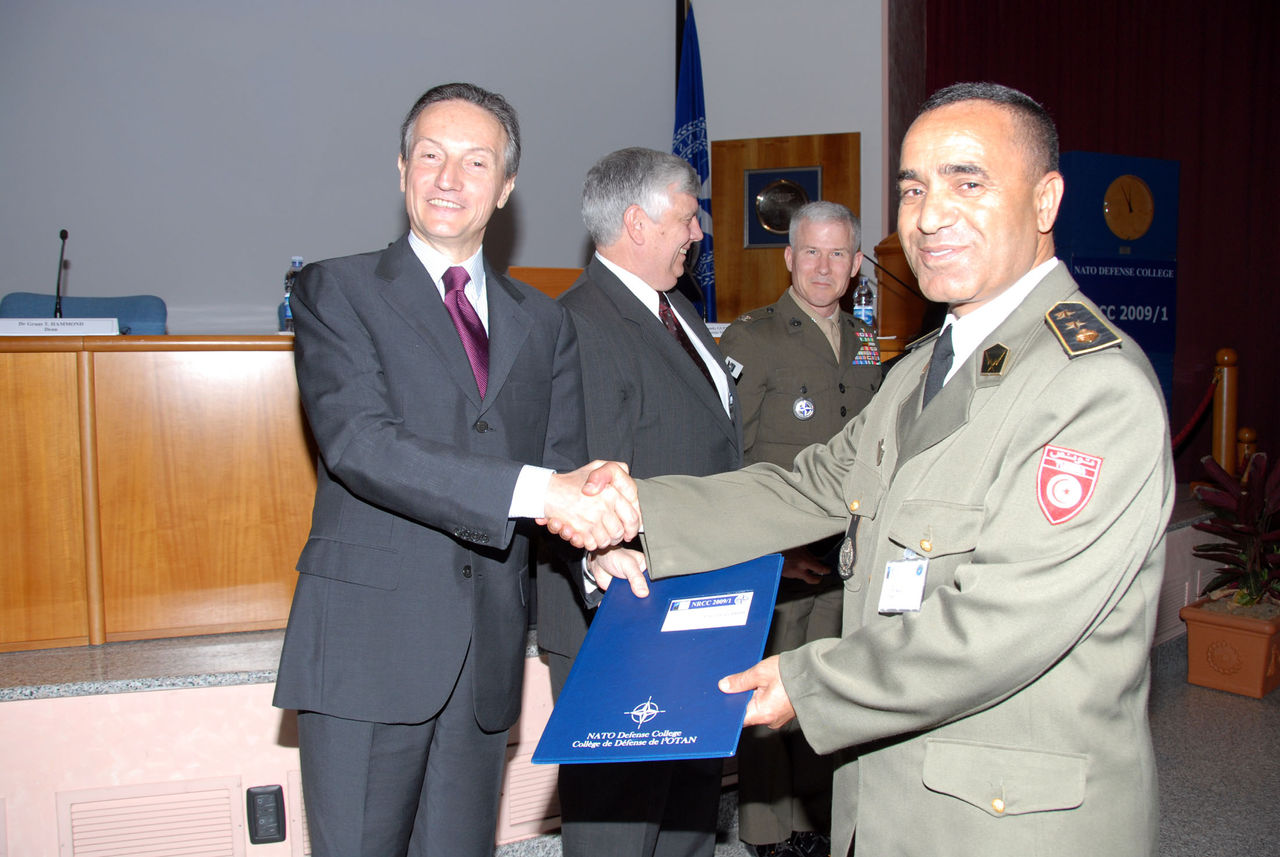 NATO Deputy Secretary General, H.E. Amb. Claudio Bisogniero, congratulating a military officer from Tunisia, Lt.Col. Lotfi Diridi
