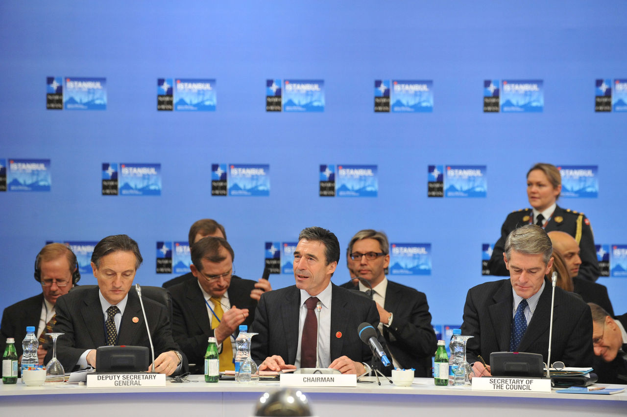 Opening remarks by NATO Secretary General Anders Fogh Rasmussen. NATO Deputy Secretary General Claudio Bisogniero (left) and the Secretary of the NATO Council Ted Whiteside (right).