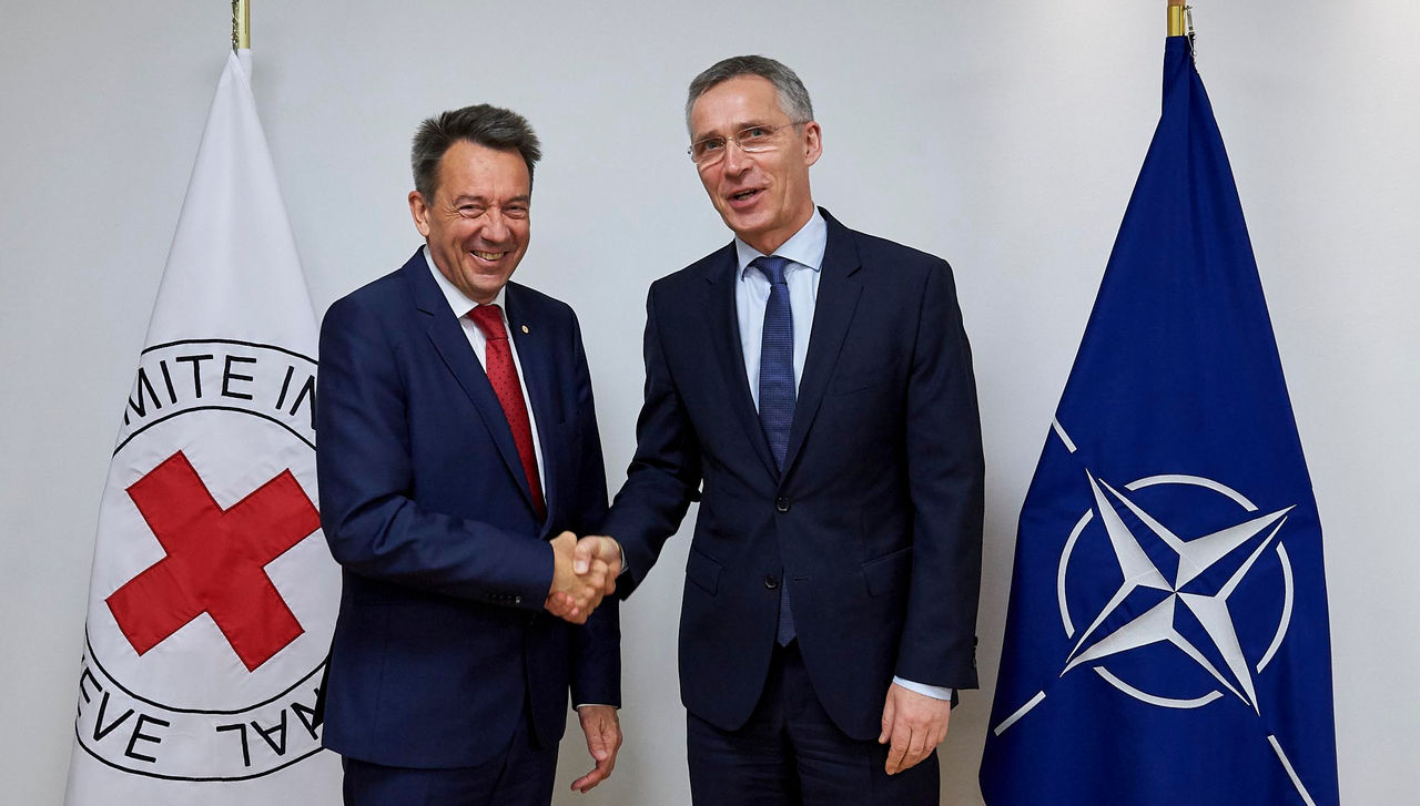 Left to right: Peter Maurer (President of the International Committee of the Red Cross) shaking hands with NATO Secretary General Jens Stoltenberg