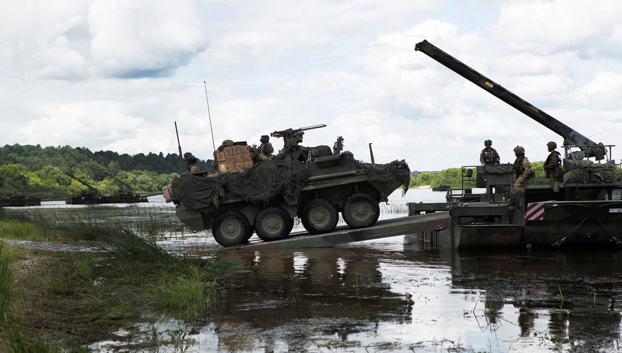 US Army Stryker vehicle driving onto amphibious rig on the river Neman in Lithuania during US-led exercise Saber Strike 18 taking place across the Baltics and Poland. It involves around 18,000 troops from 19 NATO Allies and partners. The exercise is aimed at building readiness in an integrated training environment.