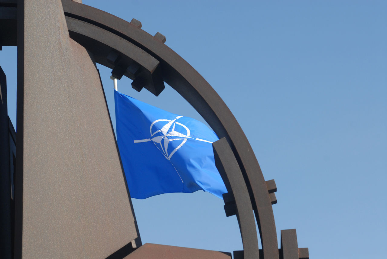 NATO flag flying at NATO Headquarters Brussels.