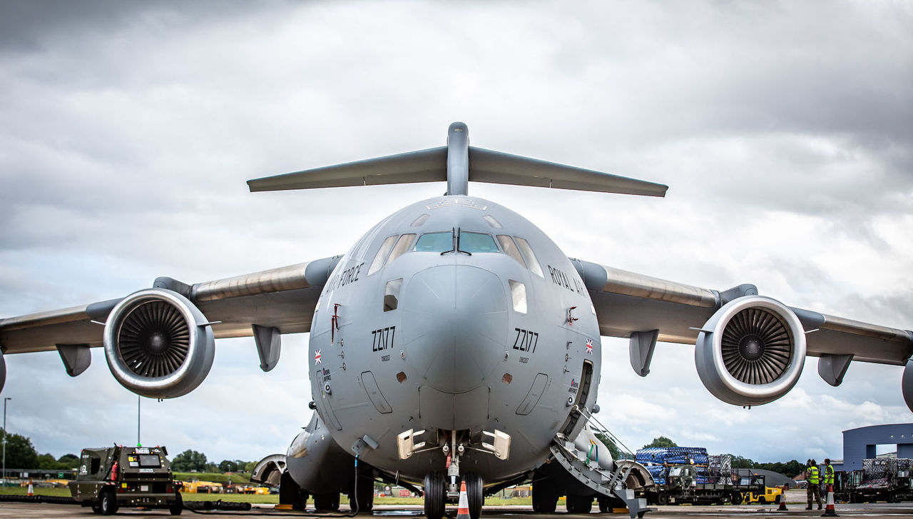 Images show 16 pallets worth of aid, that will make up a Field Hospital in Accra, being loaded on to C17 ZZ177 at RAF Brize Norton.

Royal Air Force C17 ZZ177, flown by Number 99 Squadron, departed RAF Brize Norton today with 16 pallets of aid as part of the United Nations World Food Programme.

Taking off from RAF Brize Norton at 1000, the aircraft made its way to Accra in Ghana, via Senegal, with vital supplies including tents and other equipment required in the African nation.

The 16 pallets will give the WFP the chance to build a fully working Field Hospital in Accra to help combat the on-going pandemic in Africa.
