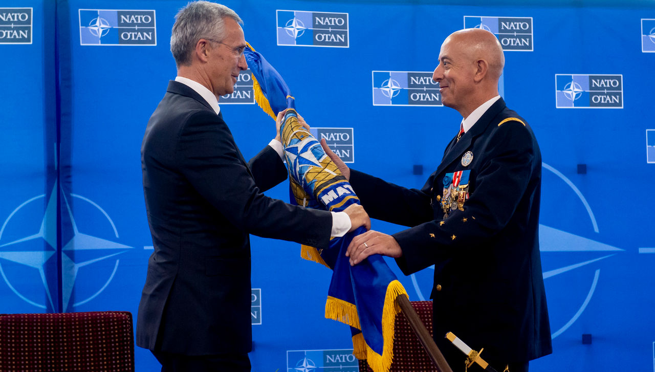 NATO Secretary General Jens Stoltenberg hands the flag to General Philippe Lavigne, incoming Supreme Allied Commander Transformation