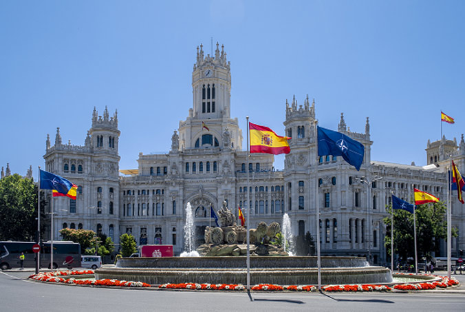 The Palacio de Cibeles (Madrid City Hall) with Spanish and NATO flags ahead of the 2022 NATO Summit in Madrid. Photo by NATO photographer.
