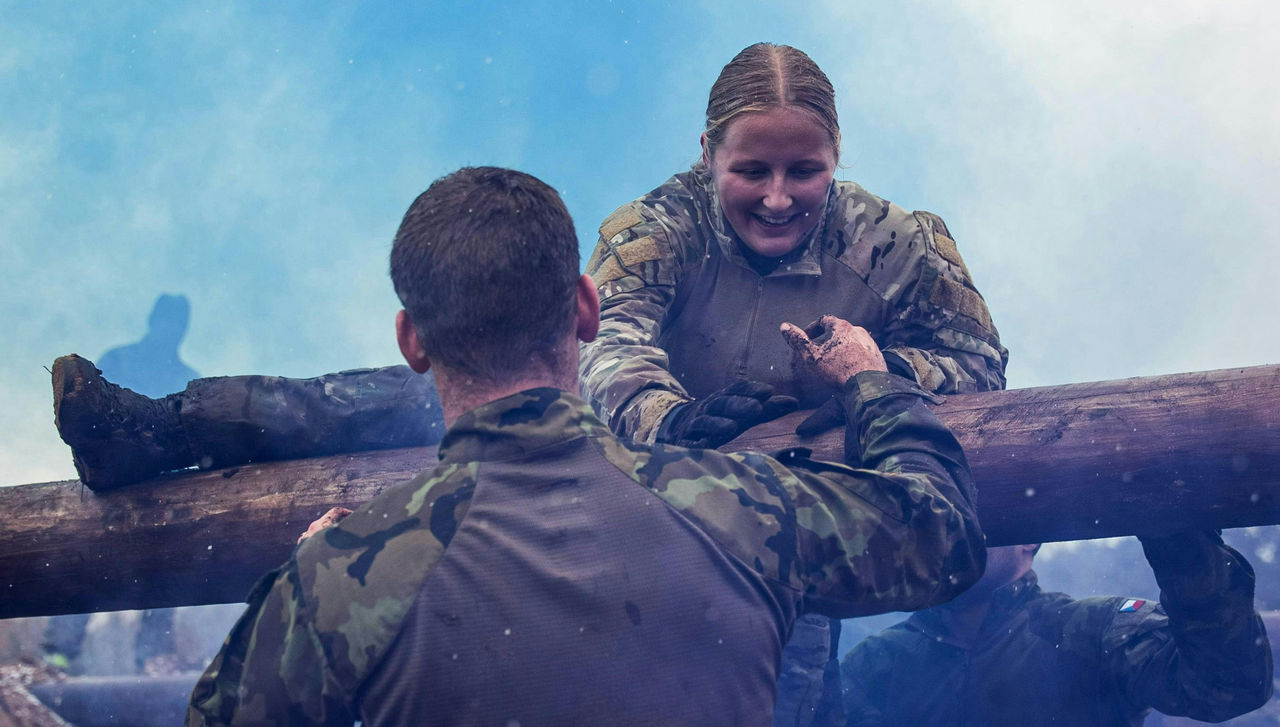 Soldiers from the NATO’s Multinational Battlegroup help each other over a log obstacle. The Czech contingent of the NATO multinational battlegroup in Lithuania hosted their ‘Czech Mudness’ competition, where soldiers had to navigate a series of challeng