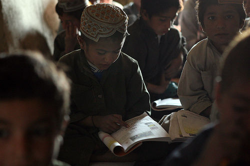 A first grade student repeats the alphabet during Pashtu study at the Khan Neshin School near The Castle in the Rig District, Nov. 2, 2009. Students travel from as far as 10 miles on foot to attend classes safe from insurgent threat.