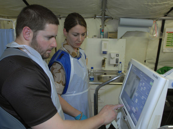 Lieutenant Jo Horn TA and Chief Petty Officer Ian Lindsey Radiographers from 306 field hosptal use their x-ray machine in a real time incident at the new field hospital at Camp Bastion.