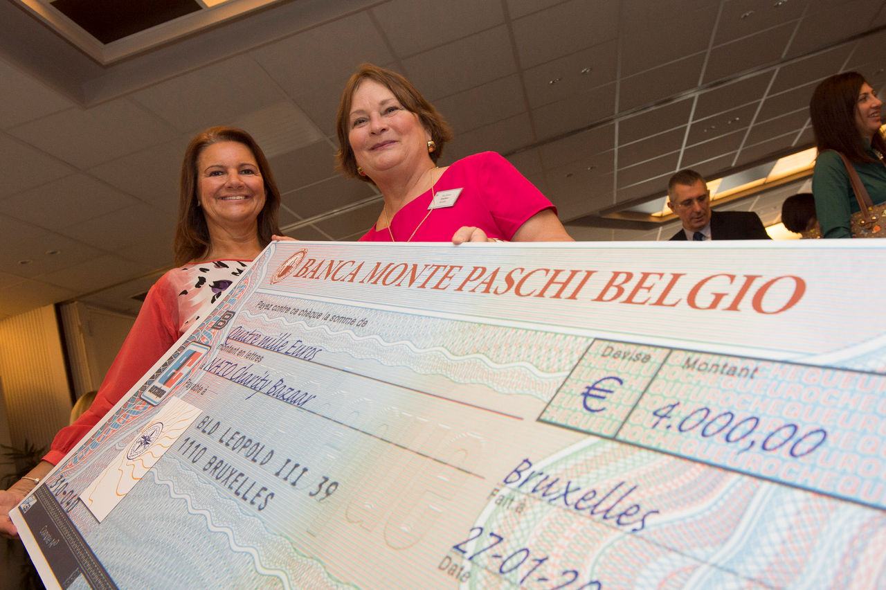 Mrs Anne-Mette Rasmussen (left) and President Mrs. Jimmie Bradshaw are pictured on Monday (27 January 2014) presenting a cheque to the NATO Charity Bazaar which donated a total of 191.000 euro in funds raised over the past year to different charitable organisations around the world.