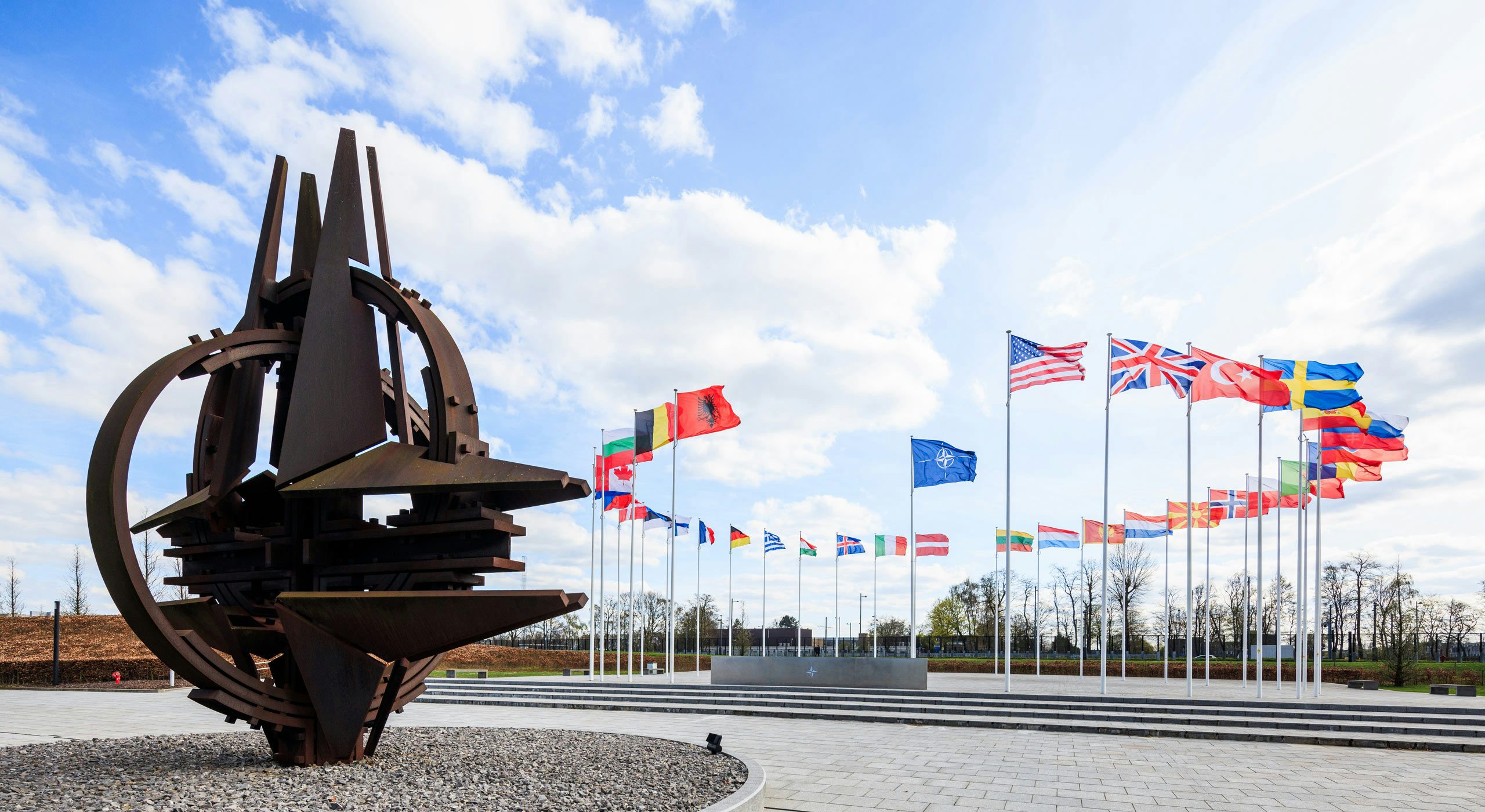 NATO flag and 32 national flags aloft. Brussels, Belgium