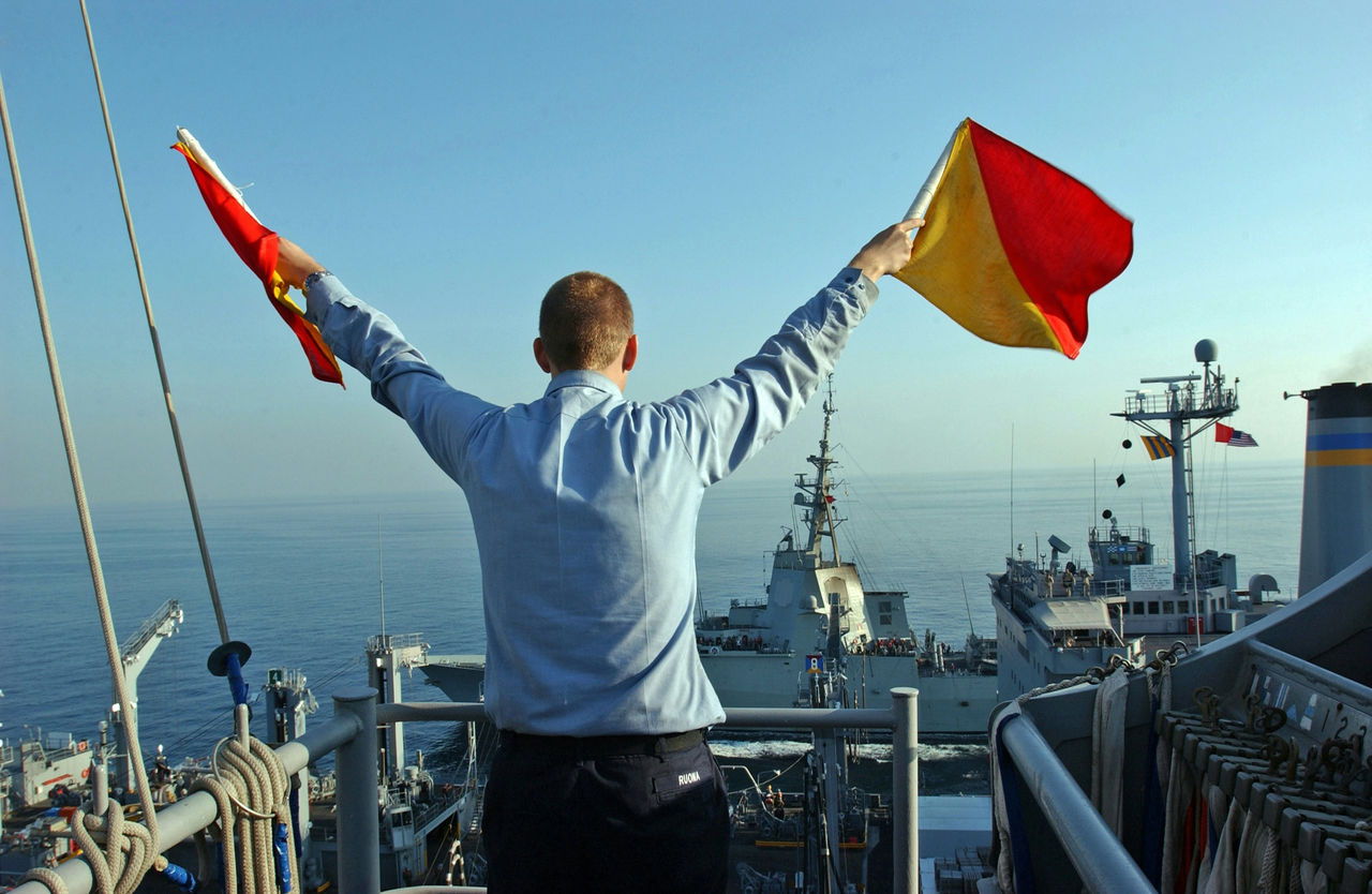 051129-N-0685C-007
Persian Gulf (Nov. 29, 2005) Ð Quartermaster Seaman Ryan Ruona signals with semaphore flags during a replenishment at sea aboard the Nimitz-class aircraft carrier USS Theodore Roosevelt (CVN 71). Roosevelt and embarked Carrier Air Wing Eight (CVW-8) are currently underway on a regularly scheduled deployment conducting maritime security operations. U.S. Navy photo by Photographer's Mate Airman Javier Capella (RELEASED)



