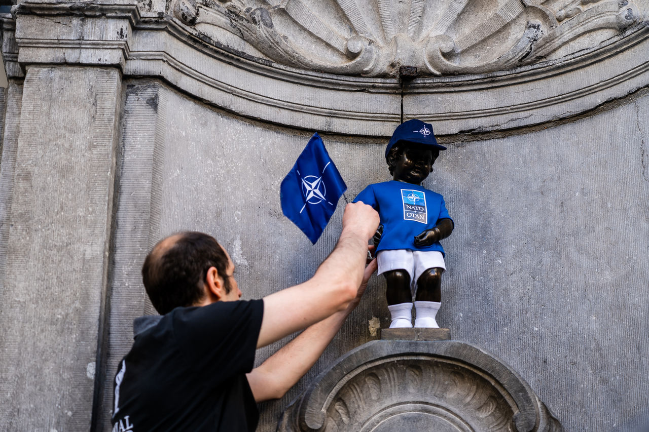 The Manneken Pis statue wears a NATO-branded outfit.