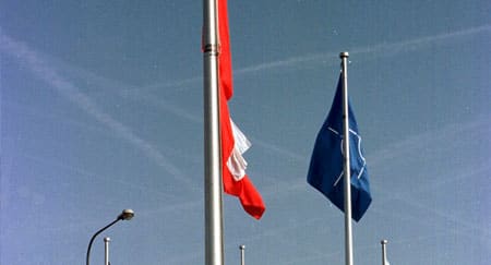 16 March 1999, NATO Headquarters: The Polish flag is raised during the ceremony to mark the accession of the Czech Republic, Hungary and Poland to the North Atlantic Treaty (© NATO)
)