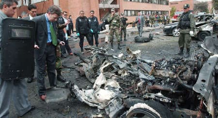 Minister Santos inspects the remains of car bomb which exploded at a military school in Bogota, Colombia. Sixteen people were injured (© AP / Reporters )
)