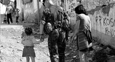 Helping hand: KFOR soldiers are helping rebuild Kosovos shattered society, as well as keeping the peace. (Nick Sidle Allied Mouse and Heartstone photo - 35Kb)
)