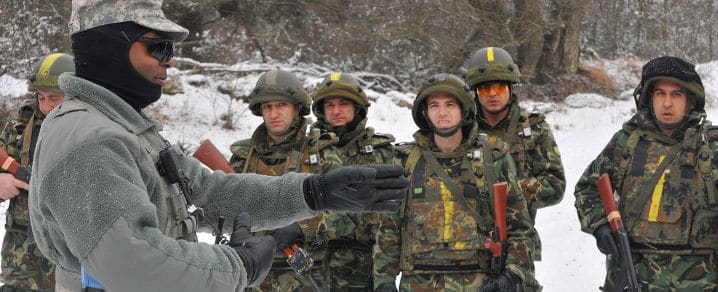 Sgt. 1st. Class Anthony Craft of U.S. Army Europe's Joint Multinational Readiness Center briefs Bulgarian soldiers on tactical movement procedures during a military advisory team training exercise at the JMRC in Hohenfels, Germany, Dec. 2. The MAT and police advisory team training programs are designed to replicate the Afghanistan operational environment while preparing teams for counterinsurgency and improvised explosive device operations and the ability to train, advise and enable Afghan security and police forces. Photo by Spc. Jordan Fuller
)