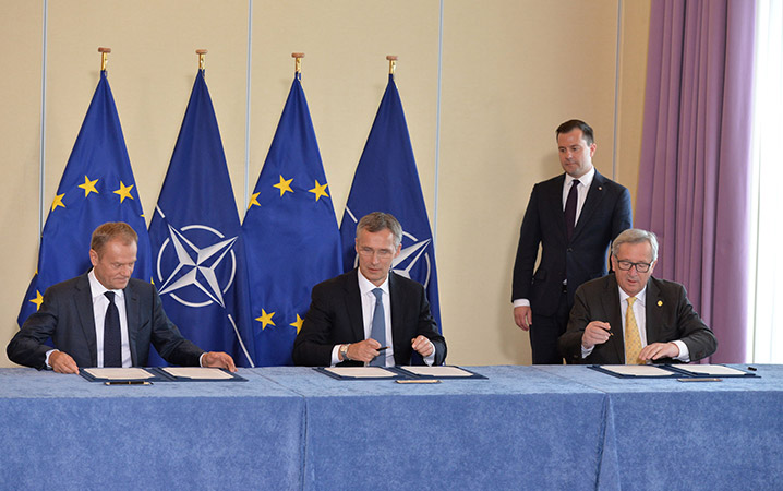  À l’heure où des défis de sécurité sans précédent émanent de l’est et du sud, le président du Conseil européen, Donald Tusk, le secrétaire général de l’OTAN, Jens Stoltenberg, et le président de la Commission européenne, Jean-Claude Juncker, signent une déclaration conjointe sur le renforcement de la coopération entre l’OTAN et l’UE – Varsovie, 8 juillet 2016. © OTAN
