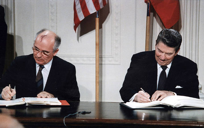 US President Ronald Reagan and General Secretary of the Communist Party of the Soviet Union Mikhail Gorbachev sign the landmark Intermediate-Range Nuclear Forces Treaty at the White House, on 8 December 1987. © White House Photographic Office
)