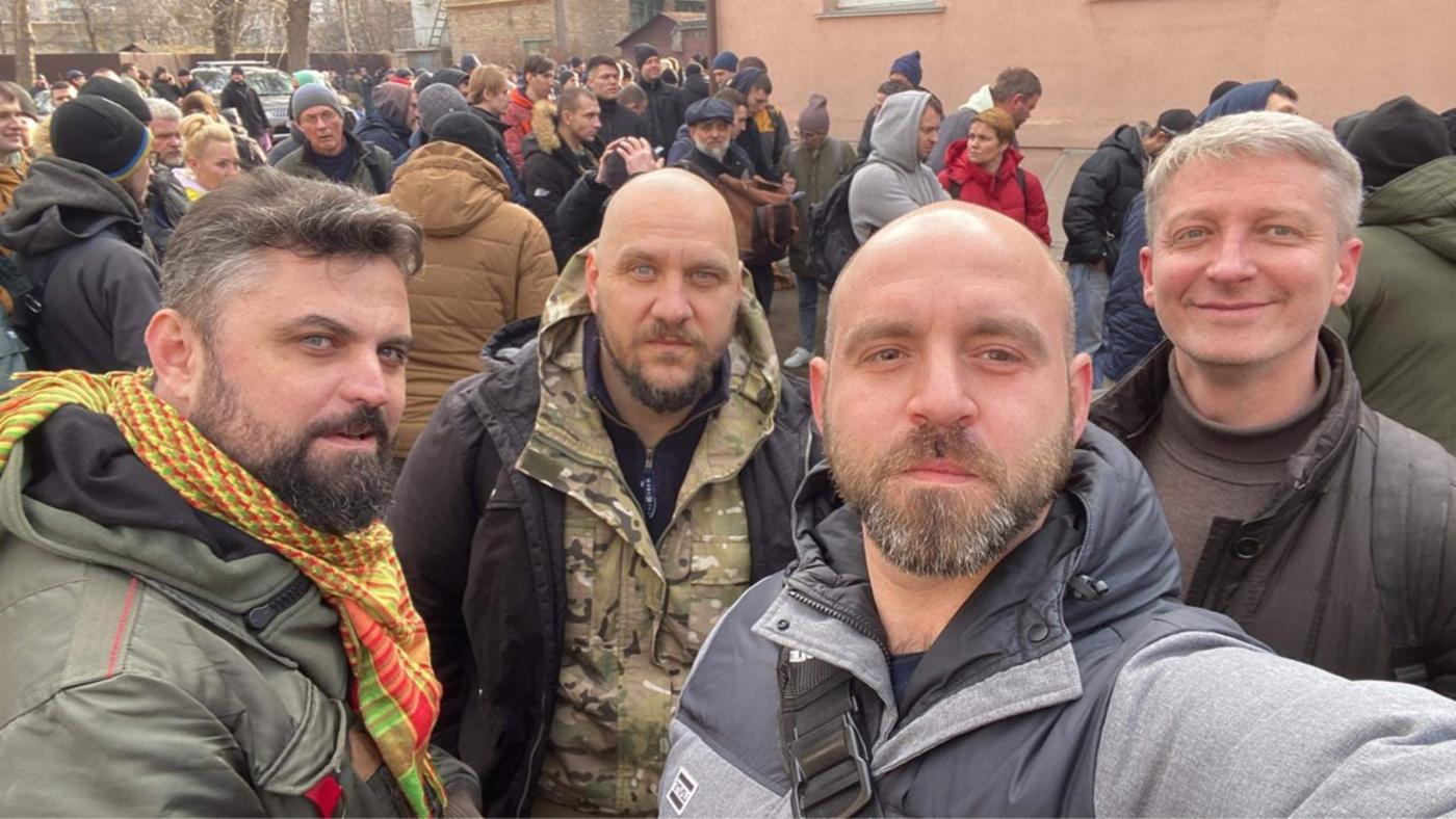 Pavlo Kazarin and others queue at the Ukraine military enlistment office on 25 February 2022.
)