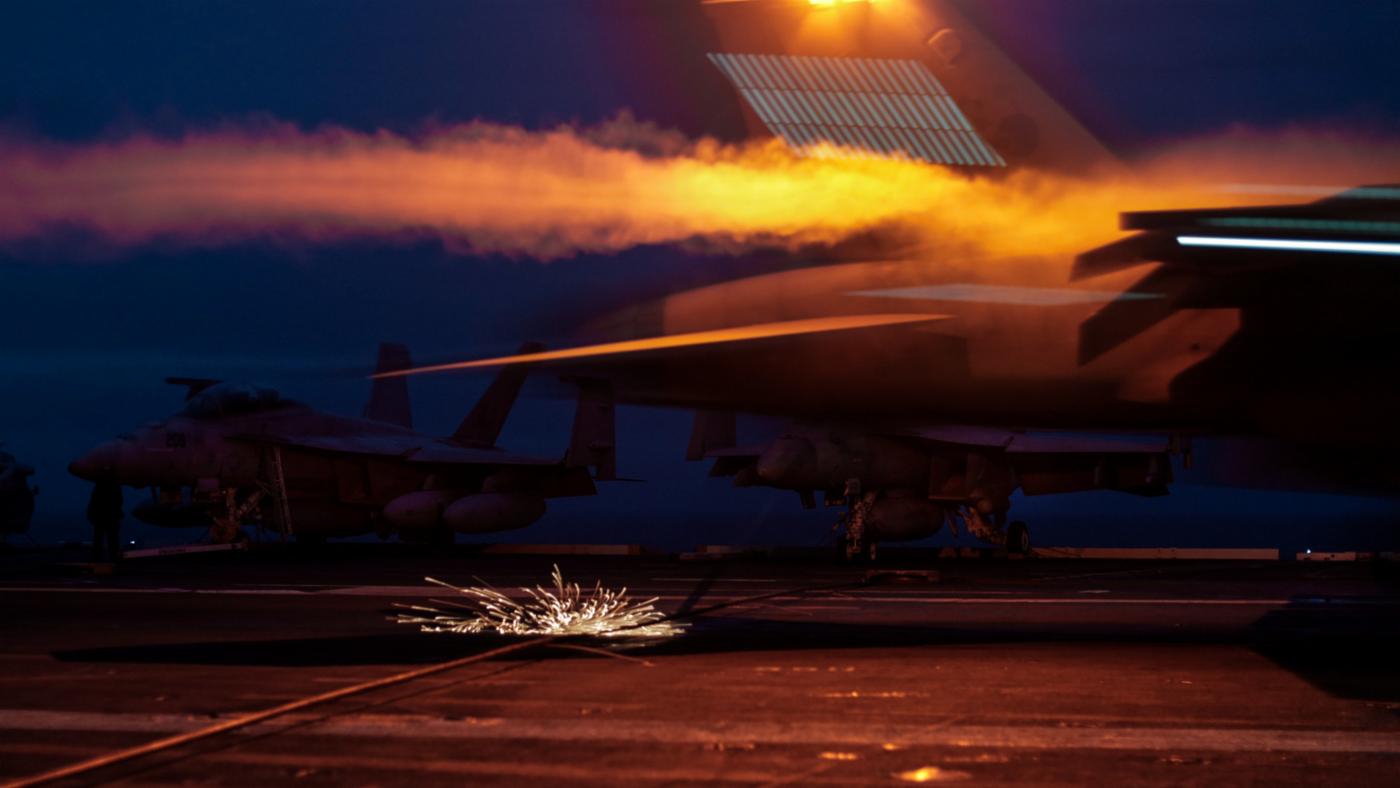 Sparks fly as the tail hook of a US Navy F/A-18 Super Hornet catches an arresting wire on the flight deck of the USS Gerald R. Ford.
)