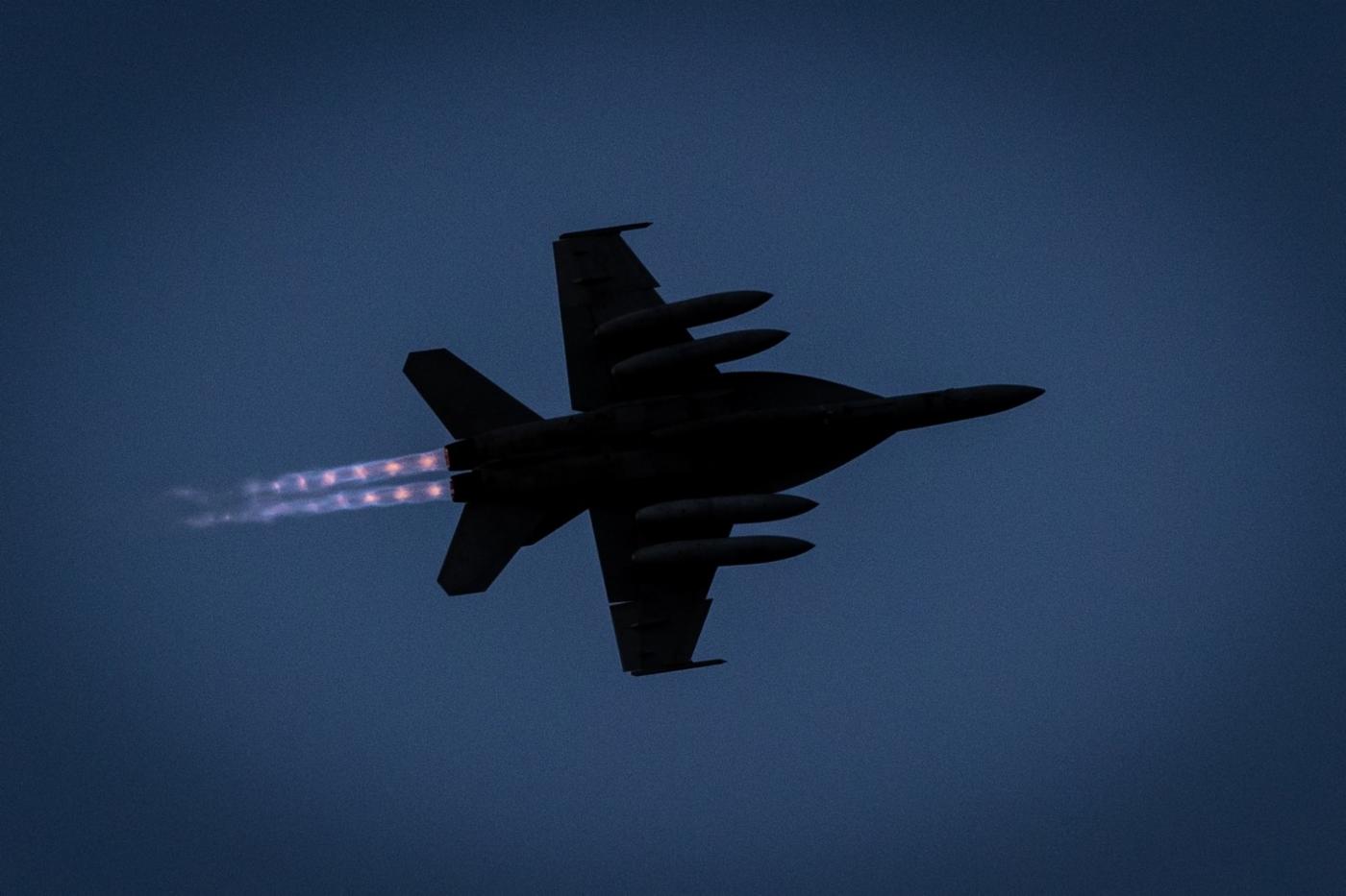 An F/A-18E Super Hornet flown by Lieutenant Commander Phillip Kunzig hits the afterburners and breaks left.
)