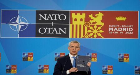 NATO Secretary General Jens Stoltenberg displays the Strategic Concept during his news conference at the NATO summit in Madrid, Spain, June 2022. © Susana Vera / Reuters
