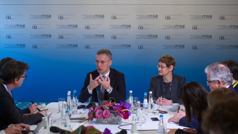 NATO Secretary General Jens Stoltenberg meeting with journalists on the margins of the Munich Security Conference. Right: NATO Spokesperson Oana Lungescu