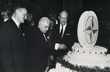 Prime Minister Benediktsson cuts NATO’s 20th anniversary cake with NATO Secretary General Manlio Brosio (left) and US Secretary of State William Rogers (right) 
