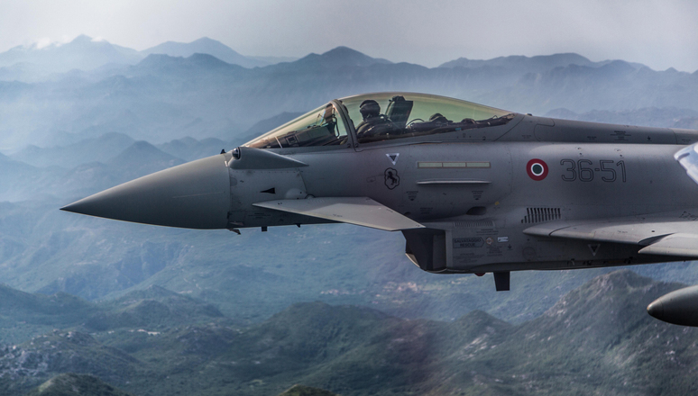 An Italian Eurofighter flies next to a Montenegrin Learjet 45 during a simulated interception exercise over Montenegro, part of the NATO Air Policing mission in the country.