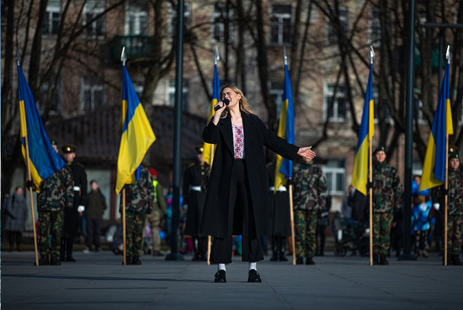 At Lithuania's NATO Day celebration - held in Vilnius on 29 March to commemorate the country's anniversary of joining NATO - a singer performs a Ukrainian song in solidarity with NATO partner country Ukraine. US Army National Guard photo by Sgt. Agustín Montañez.