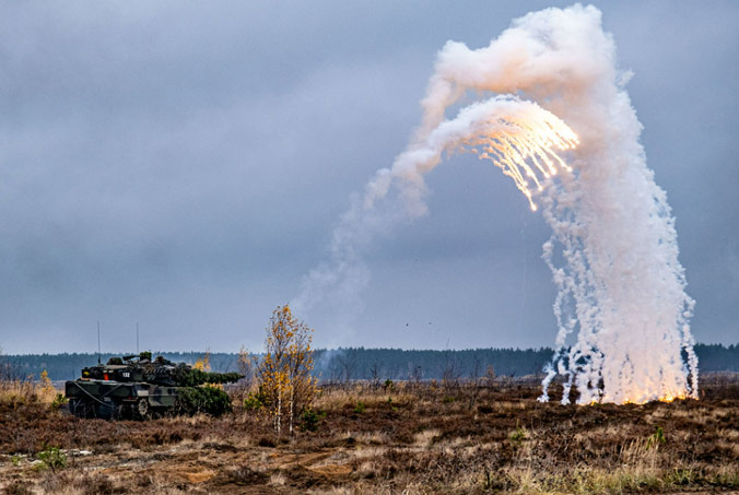 A German armoured Leopard 2 tank fires flares during exercise Iron Wolf in Lithuania. The exercise involved more than 3,500 troops from nine NATO Allies: Belgium, Czechia, Germany, Lithuania, Luxembourg, the Netherlands, Norway, the United Kingdom and the United States. Photo by NATO photographer.