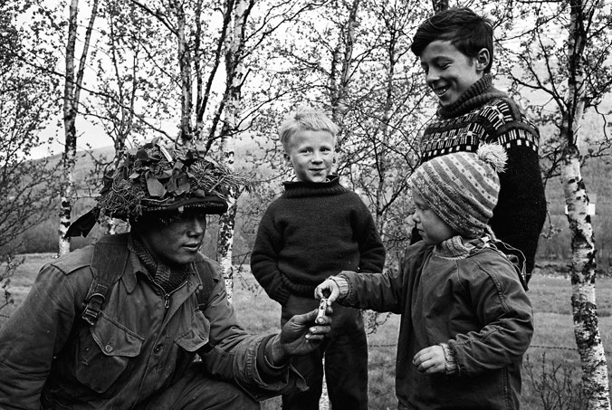 Soldier shares candy with local children during Northern Express