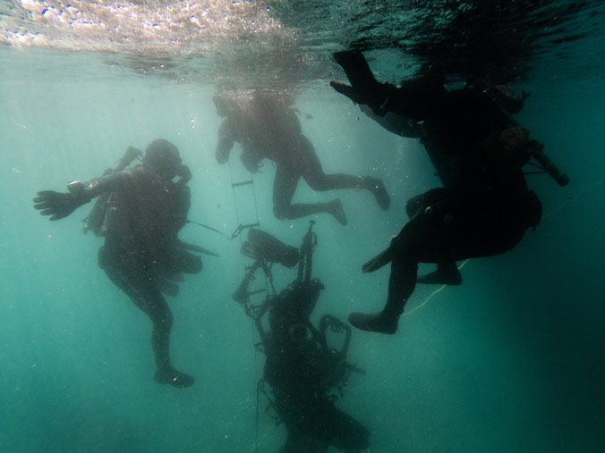 US  Navy SEALs prepare to ascend a caving ladder underwater during an exercise near  Split, Croatia.