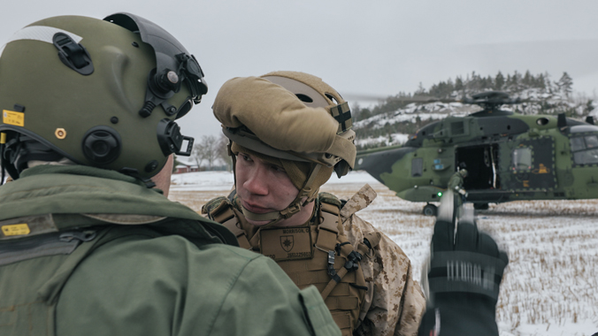 US Marines and Finnish Navy troops prepare to practise a sling-load helicopter resupply operation.