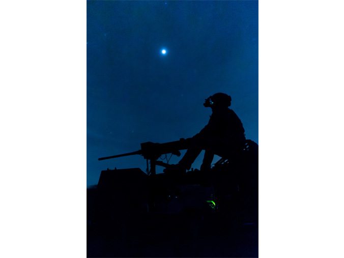 A UK Royal Marine mans an M2 .50 calibre machine gun on top of a M1288 GMV 1.1 light utility vehicle during a live-fire exercise at Grafenwöhr Training Area in Germany. (US Navy photo by LT Rob Kunzig)