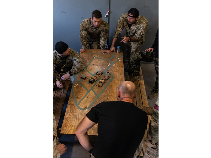 UK Royal Marines and US Green Berets run a tabletop rehearsal before conducting a training mission at Grafenwöhr Training Area in Germany. (US Navy photo by LT Rob Kunzig)