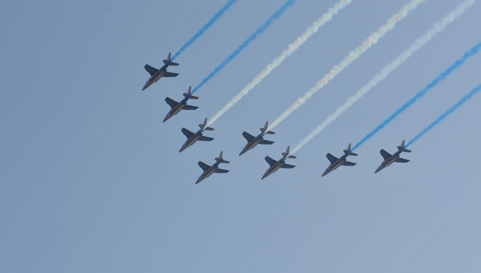 French and German airplanes fly over the 2009 Strasbourg / Kehl Summit venue, displaying the NATO colours in the sky.