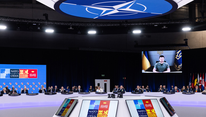 Ukrainian President Volodymyr Zelenskyy addresses NATO Heads of State and Government at the 2022 Madrid Summit.