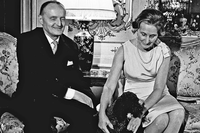 NATO's fourth Secretary General, Manlio Brosio, and his wife, Clothilde Brosio, pamper their poodle, Pulpo, who often accompanied them on official visits abroad. During a few 'ruff' occasions, Pulpo misbehaved and the visit had to be shortened (1964).