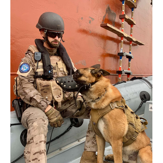 A Spanish Marine takes a well-deserved break with its human between exercises during Operation Sea Guardian; a year round, standing Maritime Security Operation in the international waters of the Mediterranean Sea, which aims to improve maritime situational awareness, counter-terrorism efforts and regional capacity-building (2022).