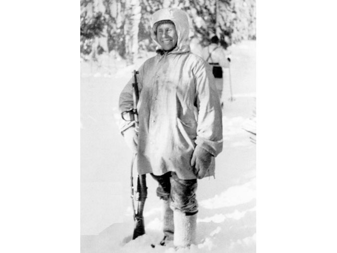 Simo Häyhä stands with a rifle in the snow. (Photo: Finnish Military Archives)