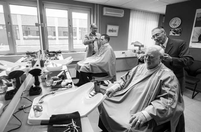 Patrice and Giuseppe with customers at their salon in the old NATO Headquarters in Brussels (from left to right)