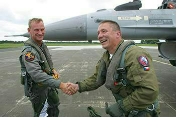Czech Lt. Col. Jaroslav Spacek (right) shakes hands with his Belgian Viper driver (left) after enjoying a high-speed back-seat ride – an extraordinary experience for someone accustomed to the airspeed of a Hind helicopter. (Photo by NATO Tiger Association)