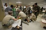 Afghan and ISAF medical personnel treat Afghan civilians wounded in an explosion that occurred north of Kandahar City.